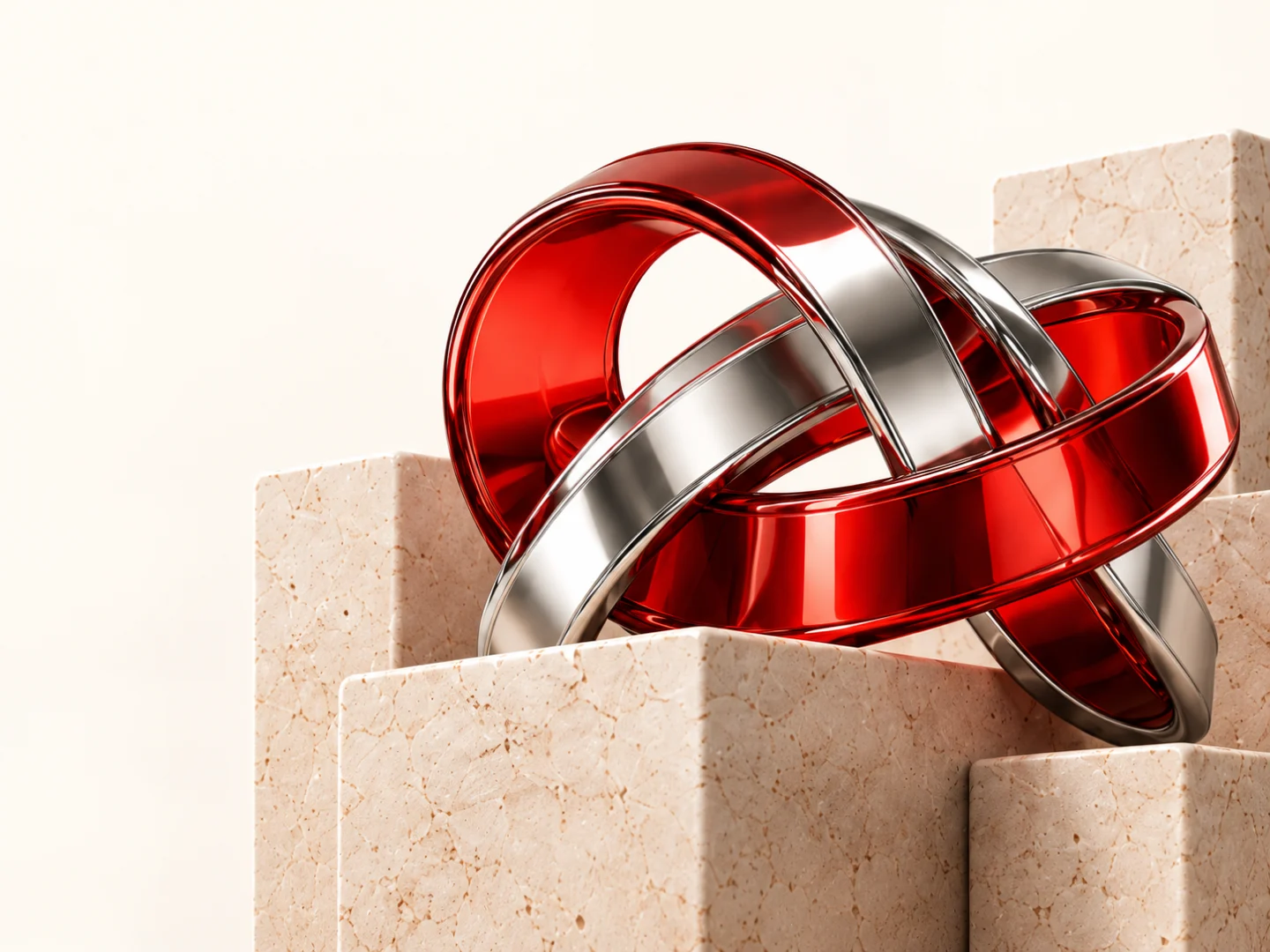 Interlocking red glass and chrome sculptures on ivory stone